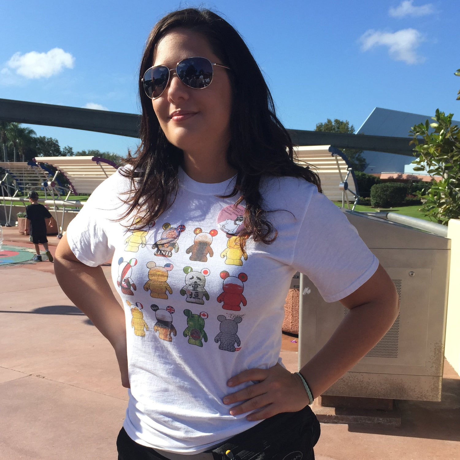 beautiful woman wearing a colorful personalized custom t-shirt at Epcot that has 13 mickey mouse outlines on it each filled with the beverage that coincides with the country it was from at the World Showcase